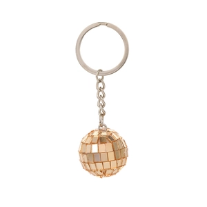 Macro detail of golden disco ball keychain with reflective mirror facets and metal chain