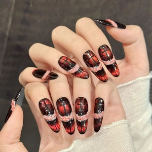 Gothic stiletto press-on nails with red-black cat-eye gradient and cross patterns