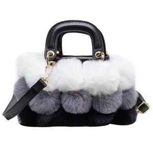Detail of plush faux fur handbag with tricolor patchwork and gold hardware accents