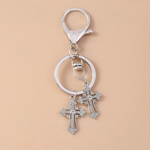 Detailed view of silver gothic keychain featuring rhinestone encrusted cross pendants