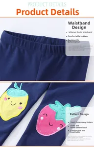 Detail of girl leggings featuring strawberry embroidery and soft elastic waistband
