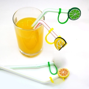 Close-up of four silicone fruit straw covers featuring lemon, watermelon, and orange designs