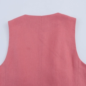 Close-up of pink linen vest back showing vertical seam and breathable fabric texture