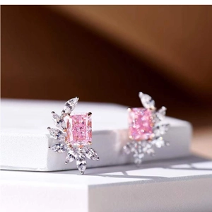 Elegant emerald-cut pink gemstone stud earrings with marquise side stones on white base