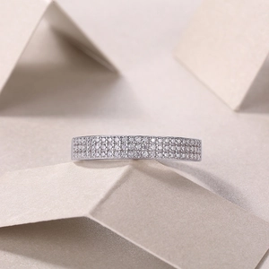 Detailed macro view showing three rows of sparkling moissanite diamonds on silver ring