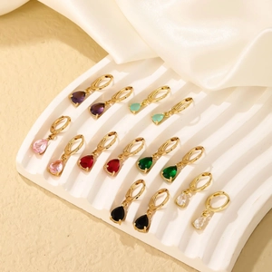 Elegant gold-plated teardrop gemstone earrings in multiple vibrant colors on white tray
