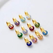 Macro shot of twelve faceted crystal moon and sun charms with gold-plated horseshoe clasps