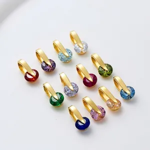 Macro shot of twelve faceted crystal moon and sun charms with gold-plated horseshoe clasps