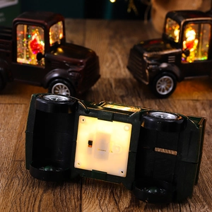 Detail view of the battery compartment and power switch on the Christmas truck lantern base