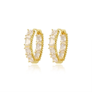 Close-up of golden huggie hoop earrings with rectangular clear cubic zirconia stones
