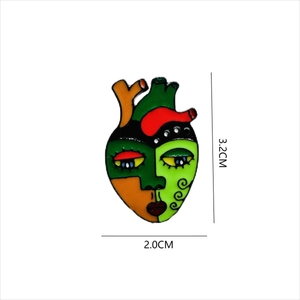 Artistic anatomical heart enamel pin with abstract face design and colorful finish