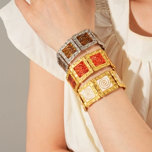 Vintage enamel square panel bracelets in silver and gold tones on model wrist