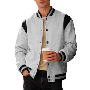 Men's grey varsity jacket with black panels and striped cuffs in a casual street style