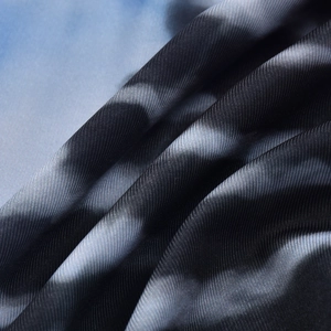 Detail shot of blue gradient twill fabric showing silky texture and weaving pattern