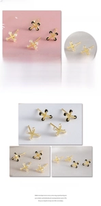Detailed views of 18k gold plated cross stud earrings with black beads and zircon stones