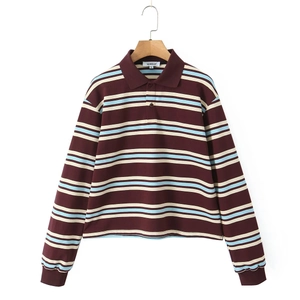 Detail of striped polo shirt with white collar and red, blue, and white pattern