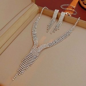 Detailed view of silver crystal drop fringe necklace and earring set in a gift box