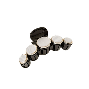 Elegant black hair claw clip with five white mother-of-pearl shells and gold edging