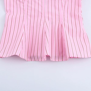 Detailed macro view of pink and white vertical striped fabric with delicate ruffled hemline