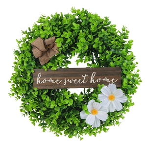 Artificial floral wreath with home sweet home wooden sign and rustic burlap bow decor
