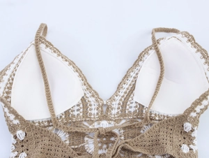 Detailed close-up of crochet top showing internal white pads and knit texture