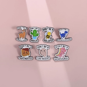 Detailed view of creative enamel pins featuring cartoon animals and funny quote slogans