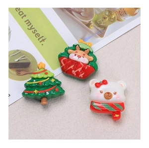Macro detail of resin Christmas charms including tree, white bear and reindeer for DIY crafts