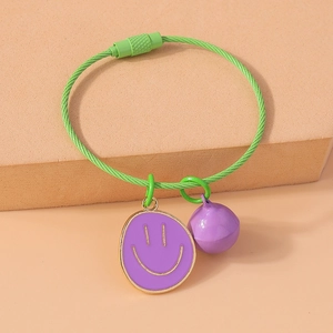 Detail view of green rope keychain featuring purple smiley face charm and matching purple bell