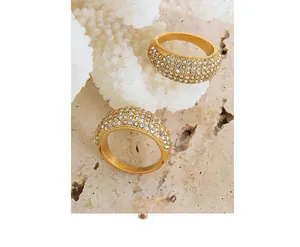 Detailed macro view of gold-plated wide dome ring with shimmering pave-set zircon stones