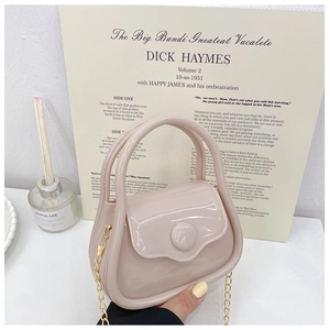 Close-up of mini light pink jelly bag with golden chain strap and smooth handle detail