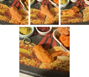 Close-up of realistic faux fried chicken wing and drumstick keychains with metal rings