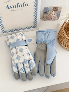 Close-up of winter ski gloves with anti-slip palms and teddy bear pattern design