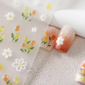 Detail of 3D embossed tulip and daisy nail art stickers with frosted gold accents