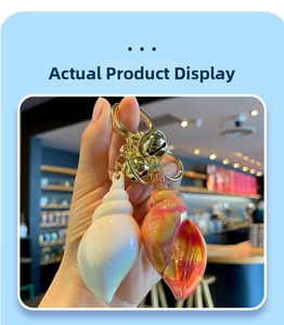 Detail of colorful acrylic conch keychains with gold metal rings and small bells