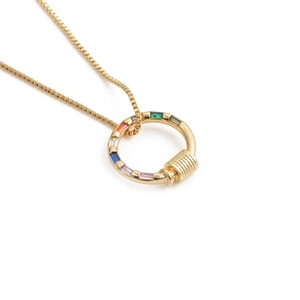 Detailed close-up of a gold box chain necklace with a colorful gemstone pendant