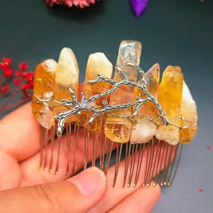 Macro detail of handmade silver hair comb featuring raw yellow crystals and branch motifs