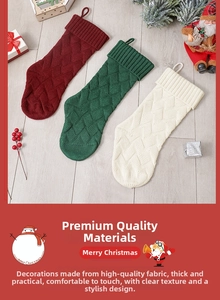 Close-up of three knitted Christmas stockings with cable patterns in red, green, and white