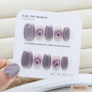 Purple cat-eye press-on nails with silver glitter edges and bow accents in four sizes