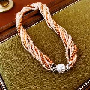 Detail of multi-strand beaded necklace with a sparkling pavé crystal magnetic clasp