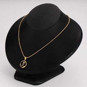 Elegant gold stainless steel snake chain necklace with black rose pendant on mannequin