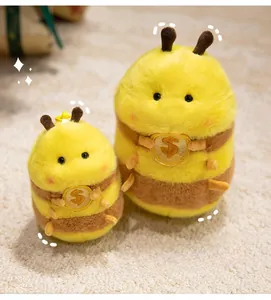 Detail of plush bee dolls in two sizes with soft yellow fur and gold sequin accents