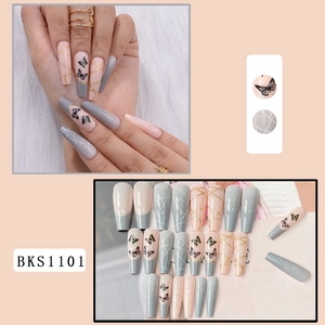 Macro view of long French nude nails with black butterfly patterns and gold lines