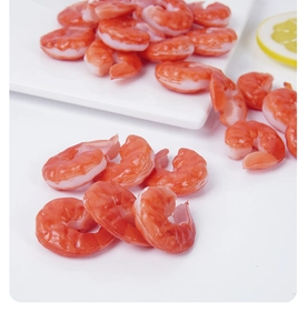 Detailed view of realistic PVC artificial shrimp tails with lifelike muscle texture on a tray