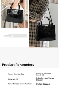 Detail of black crocodile pattern shoulder bag with metallic buckle and twin carry handles