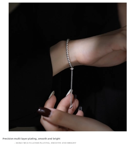 Close-up of adjustable S925 silver beaded bracelet with tassel and multi-layer plating