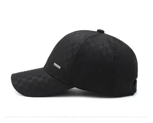 Detail view of the black plaid baseball cap featuring a premium metal side emblem and texture