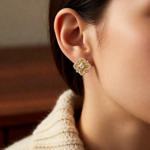Close-up of gold plated floral earrings with cubic zirconia on model for a vintage look