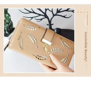 Close-up of beige PU leather long wallet featuring laser-cut leaf pattern and gold clasp
