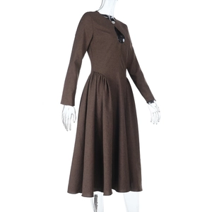 Detailed close-up of brown long sleeve dress featuring teardrop cutout and crew neckline