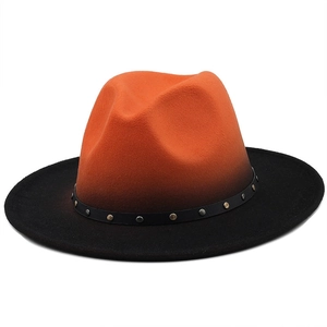 Detail of gradient felt fedora with black leather band and bronze metal studs